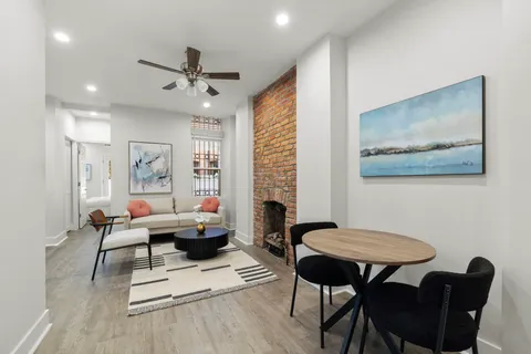 a living room with furniture a rug and a chandelier