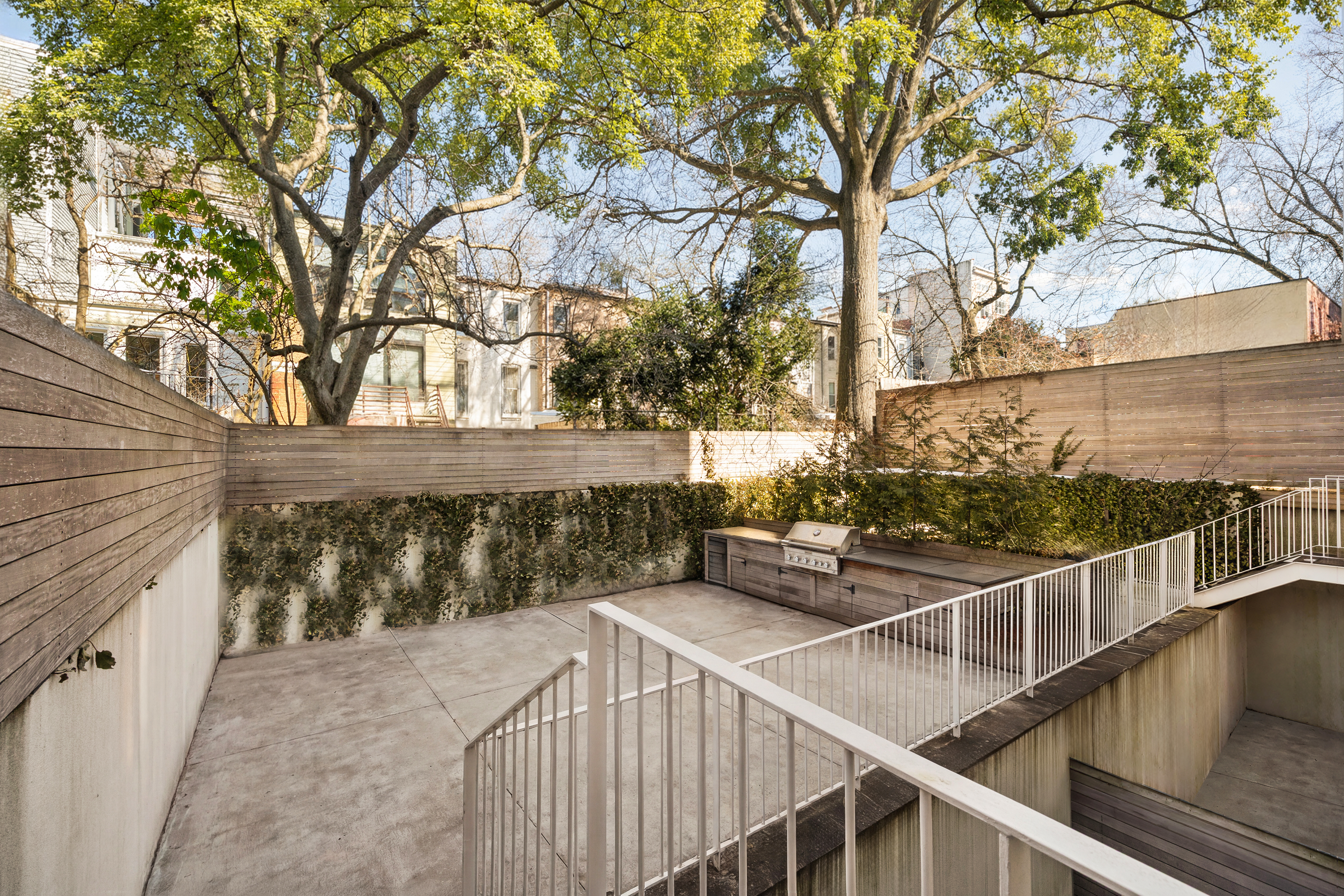 225 14th Street, Unit GARDEN A Brooklyn, NY 11215 - Photo 11 of 13 a view of house with wooden deck and trees