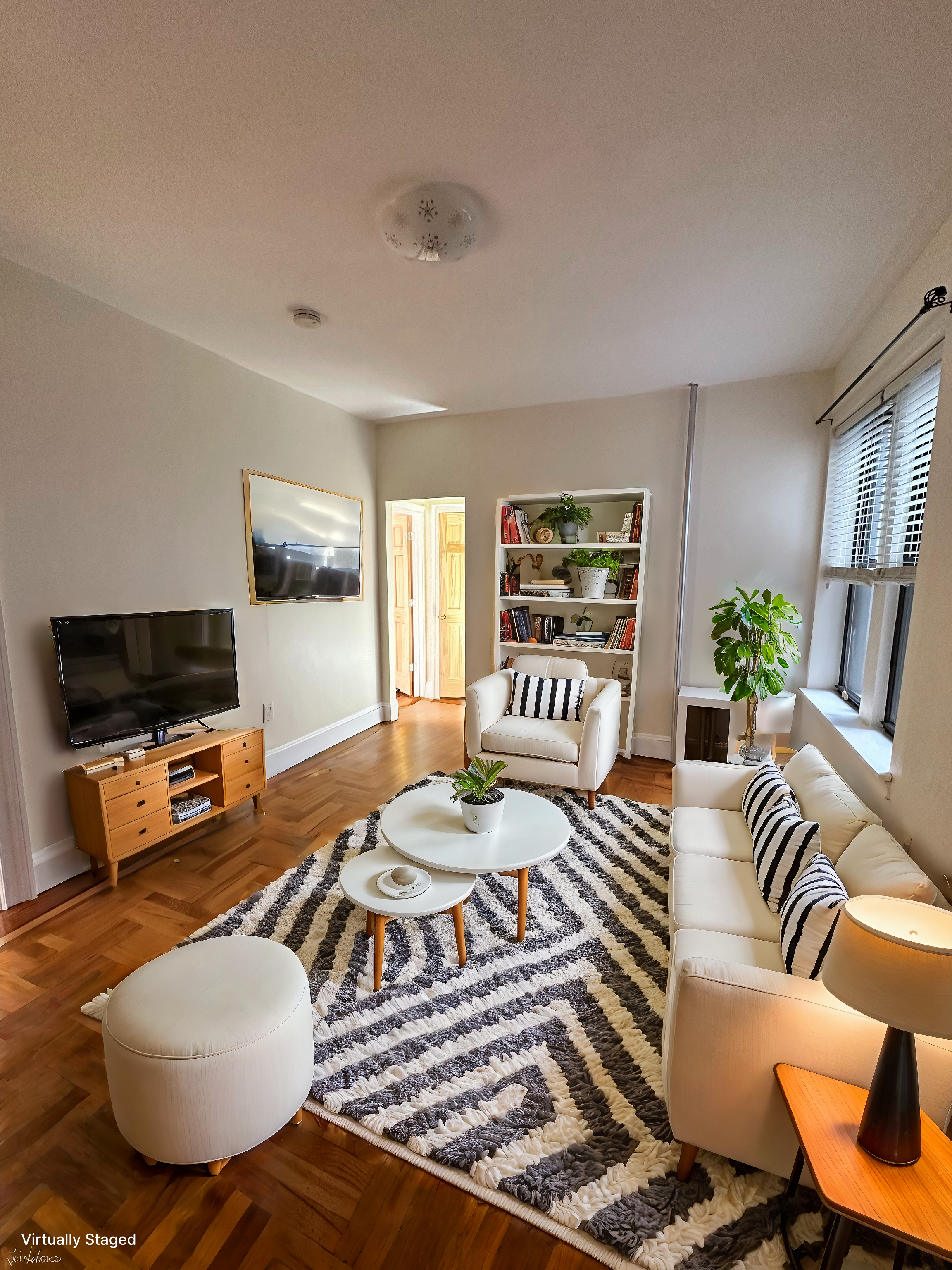 31-40 42nd Street, Unit 1F Queens, NY 11103 - Photo 2 of 9 a living room with furniture and a flat screen tv