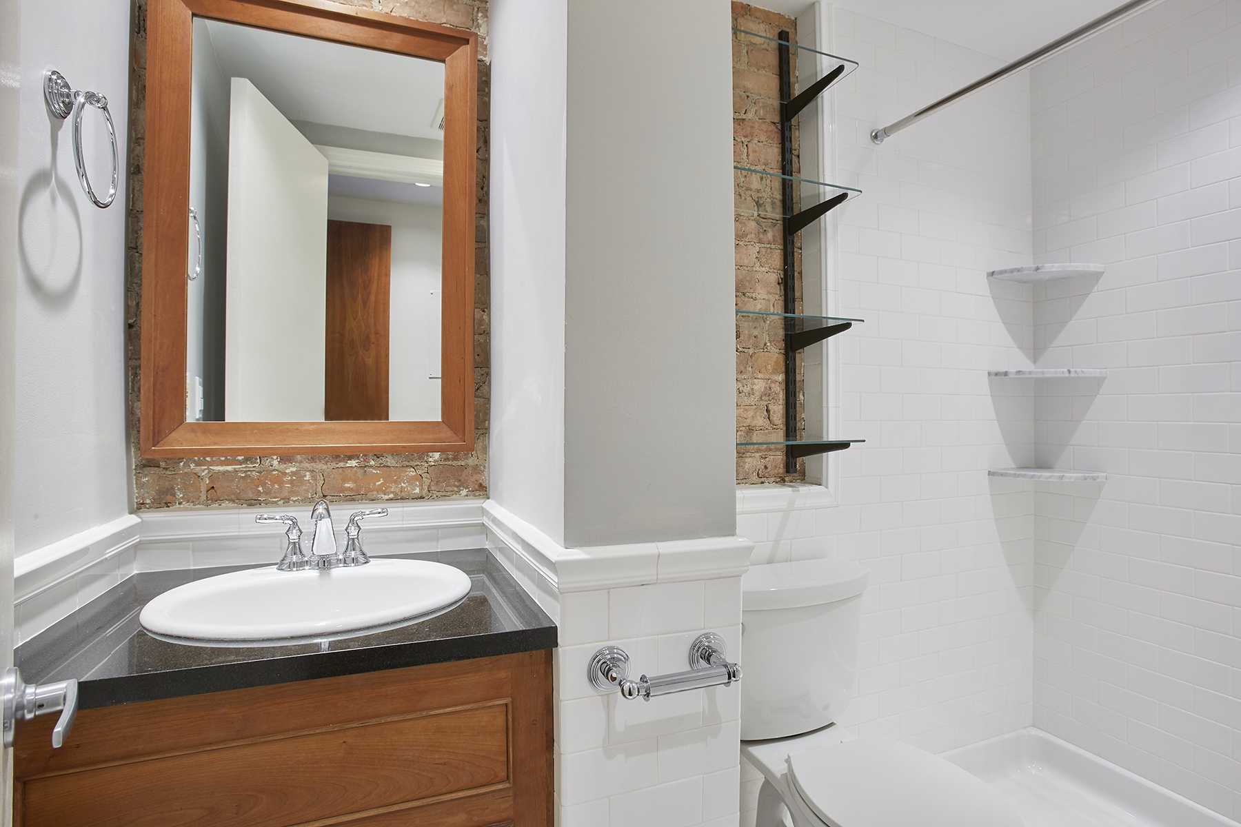 6 Bank Street, Unit 3 Manhattan, NY 10014 - Photo 4 of 6 a bathroom with a sink and a mirror