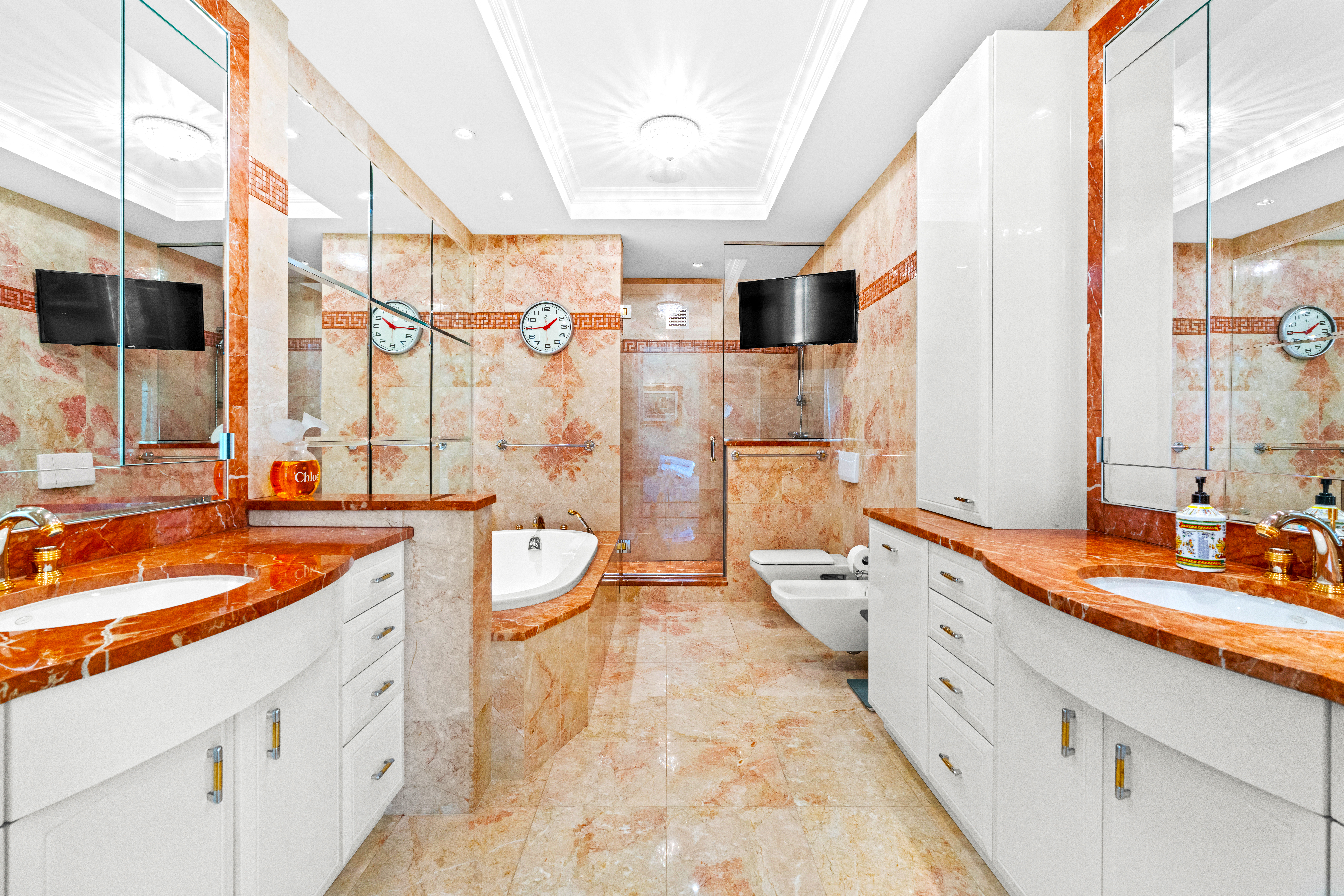 1965 Broadway, Unit 26EF Manhattan, NY 10023 - Photo 19 of 32 a spacious bathroom with double vanity two mirror and bathtub
