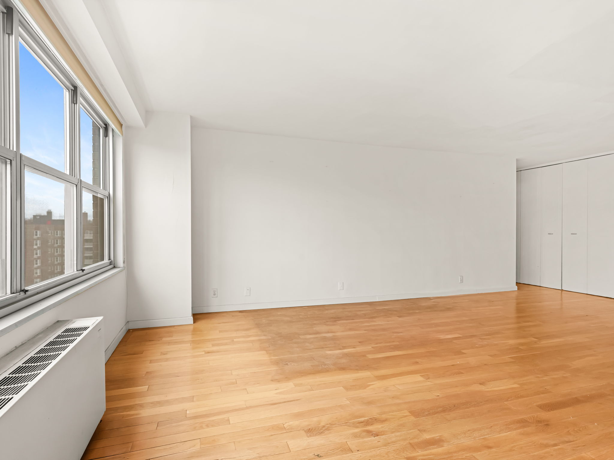 555 Kappock Street, Unit 11J Bronx, NY 10463 - Photo 5 of 24 a view of an empty room with a window