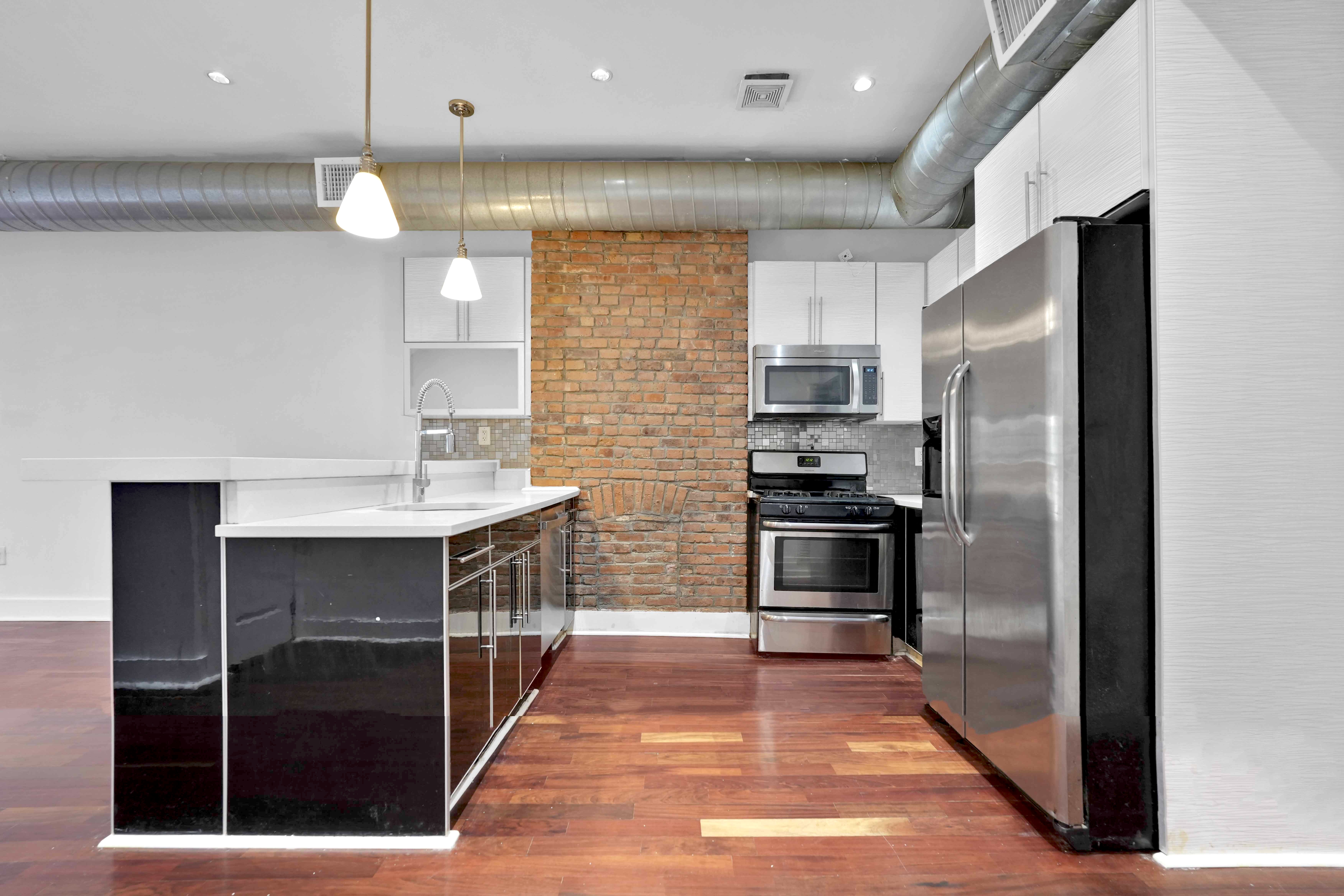 17 A Suydam Place, Unit 2 Brooklyn, NY 11233 - Photo 8 of 28 a kitchen with kitchen island a counter top space appliances and a counter top space