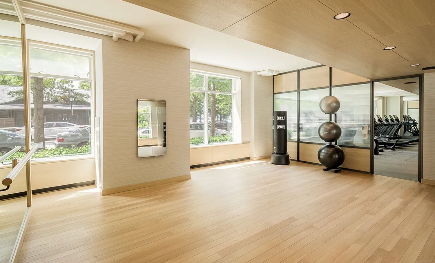 a view of a room with gym equipment and large windows