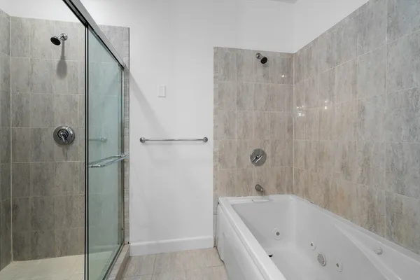 a bathroom with a bathtub and shower