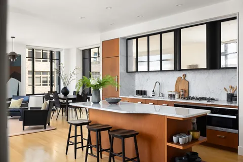 a kitchen with a table chairs stove and cabinets