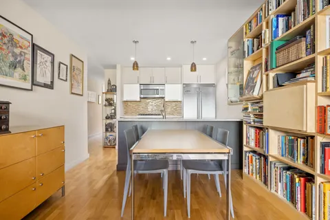 a kitchen view with appliances cabinets and a table