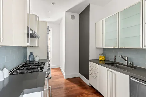 a kitchen with stainless steel appliances granite countertop a refrigerator and a stove