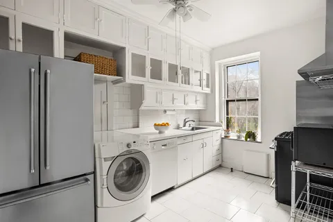 a kitchen with a refrigerator and cabinets