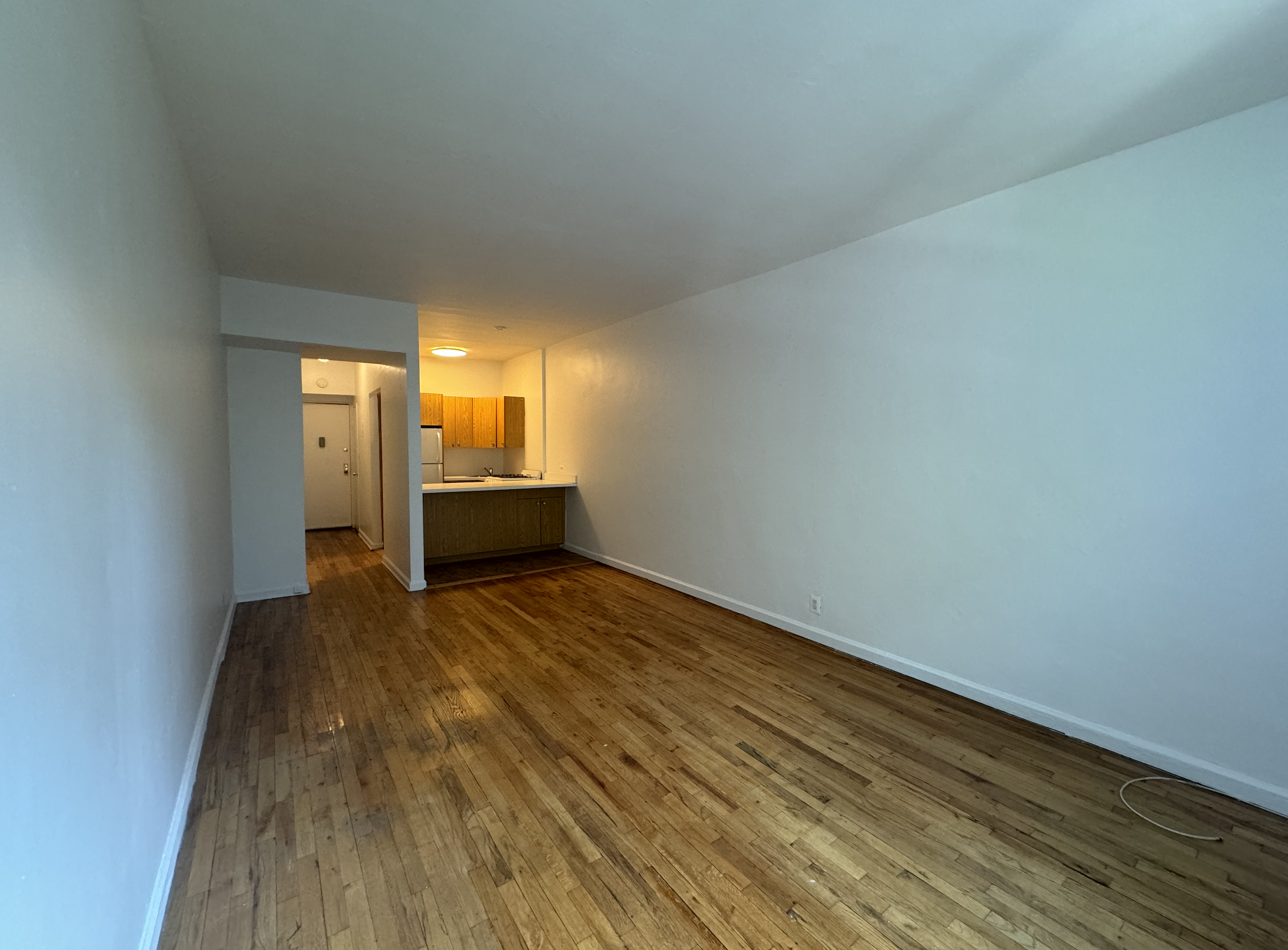 445 West 48th Street, Unit 2D Manhattan, NY 10036 - Photo 7 of 18 a view of empty room with wooden floor