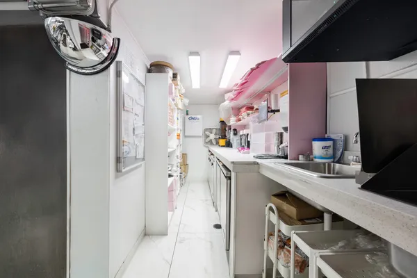 a kitchen with a sink a stove and a refrigerator