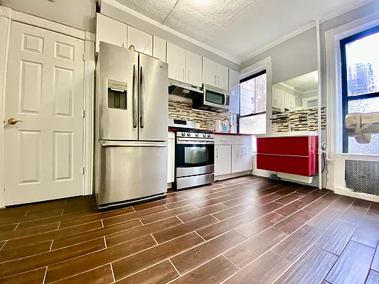 254 Wyckoff Street, Unit 2L Brooklyn, NY 11217 - Photo 3 of 8 a kitchen with stainless steel appliances granite countertop a refrigerator a stove and a wooden floors