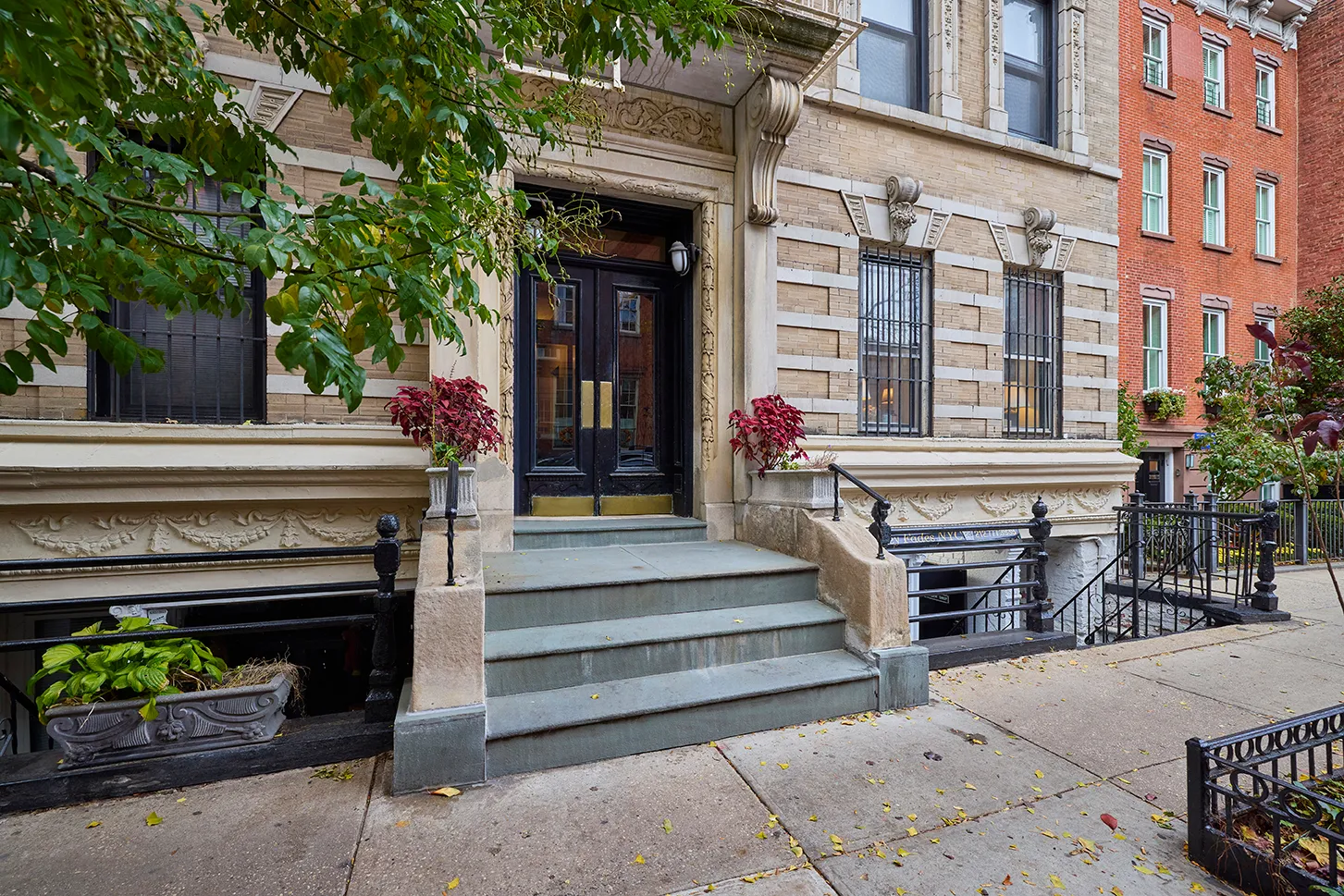 a front view of a building with outdoor seating and plants