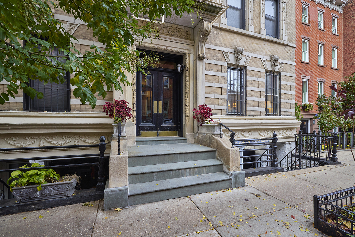 227 West 11th Street, Unit 2 Manhattan, NY 10014 - Photo 7 of 8 a front view of a building with outdoor seating and plants