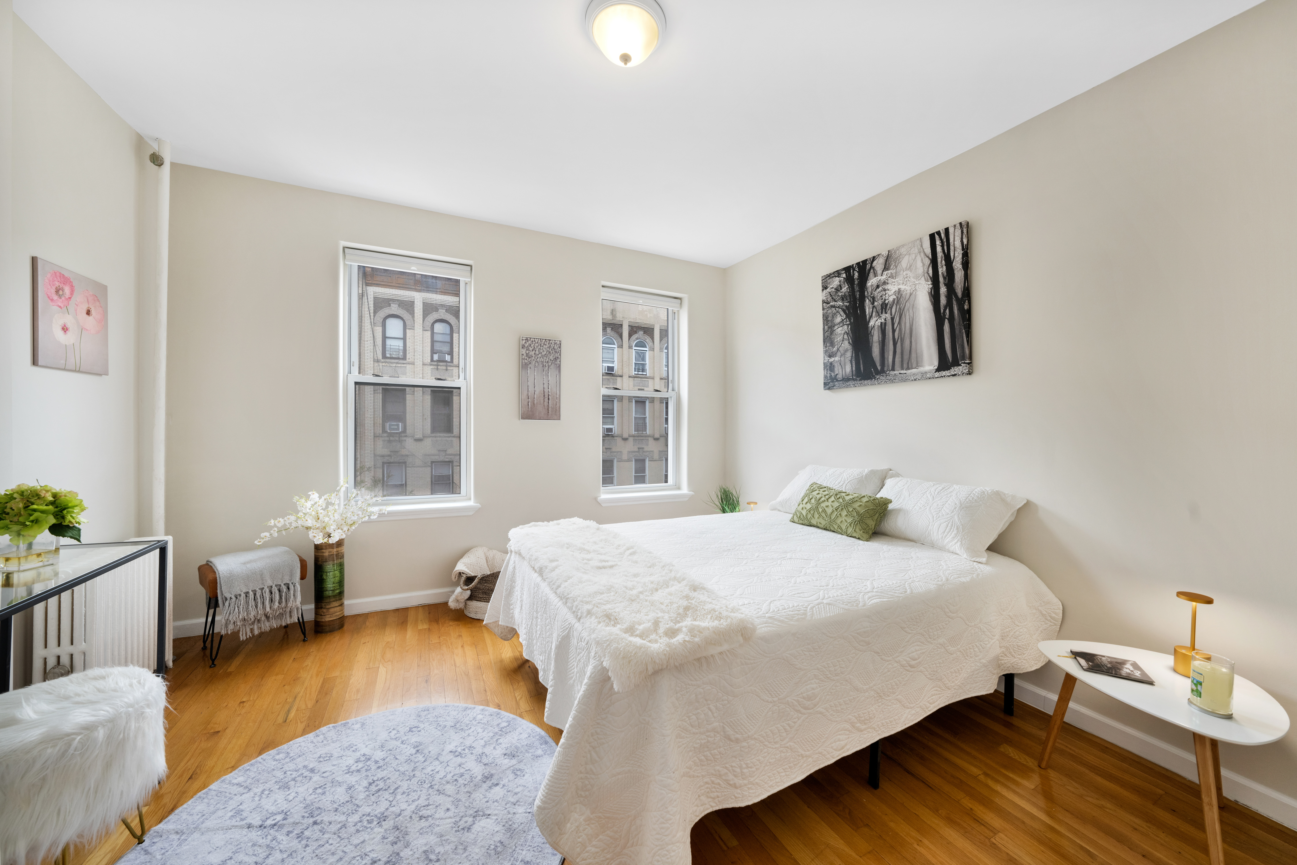 1286 Halsey Street, Unit 3B Brooklyn, NY 11237 - Photo 2 of 10 a bedroom with a bed and wooden floor