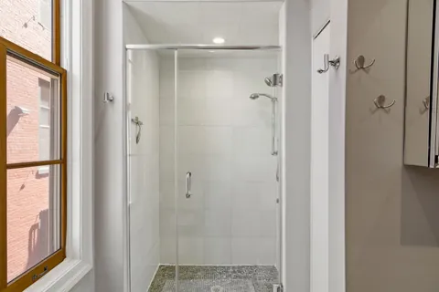 a bathroom with a glass shower door