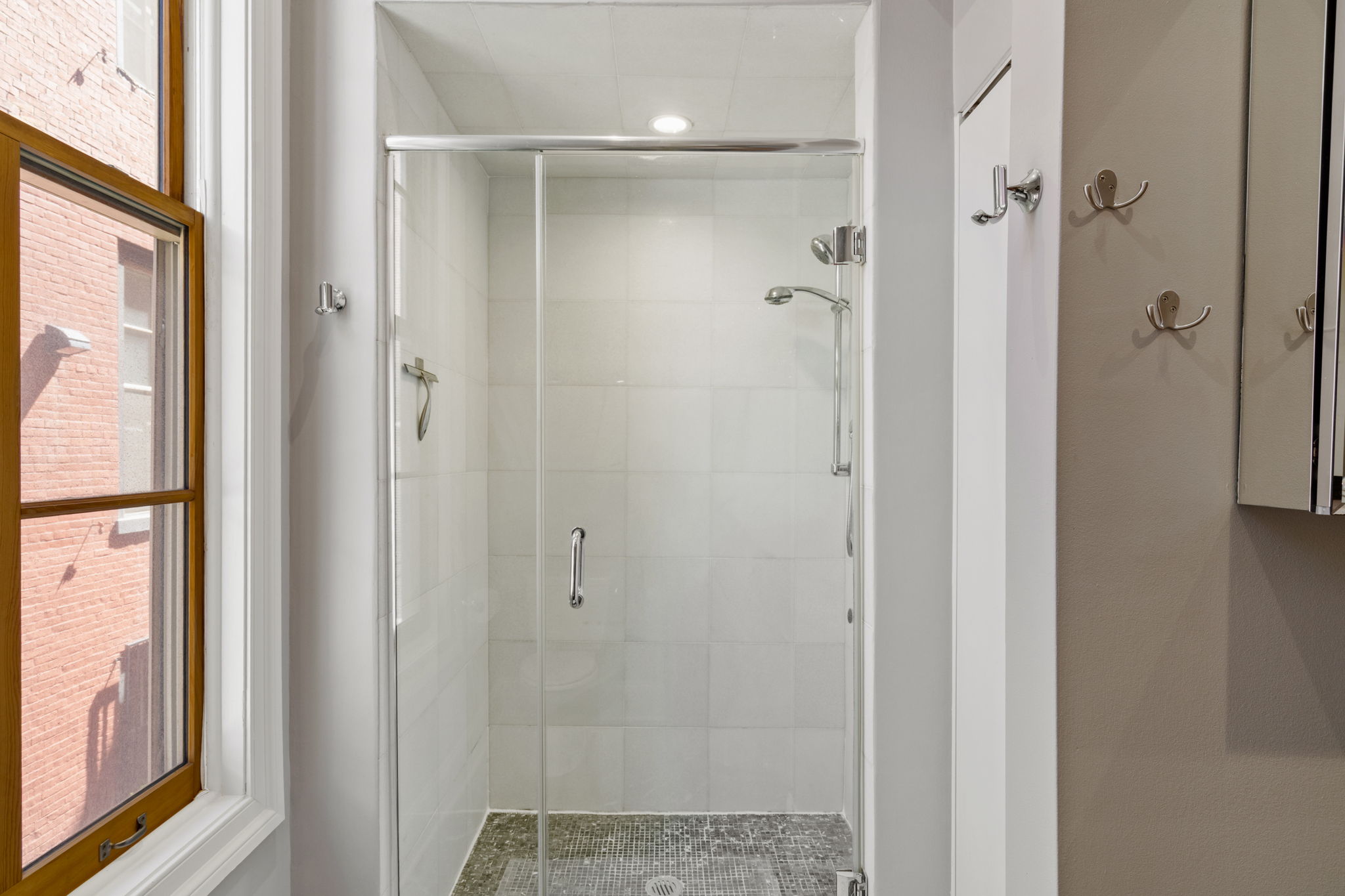 2049 Walnut Street, Unit 1R Philadelphia, PA 19103 - Photo 16 of 18 a bathroom with a glass shower door