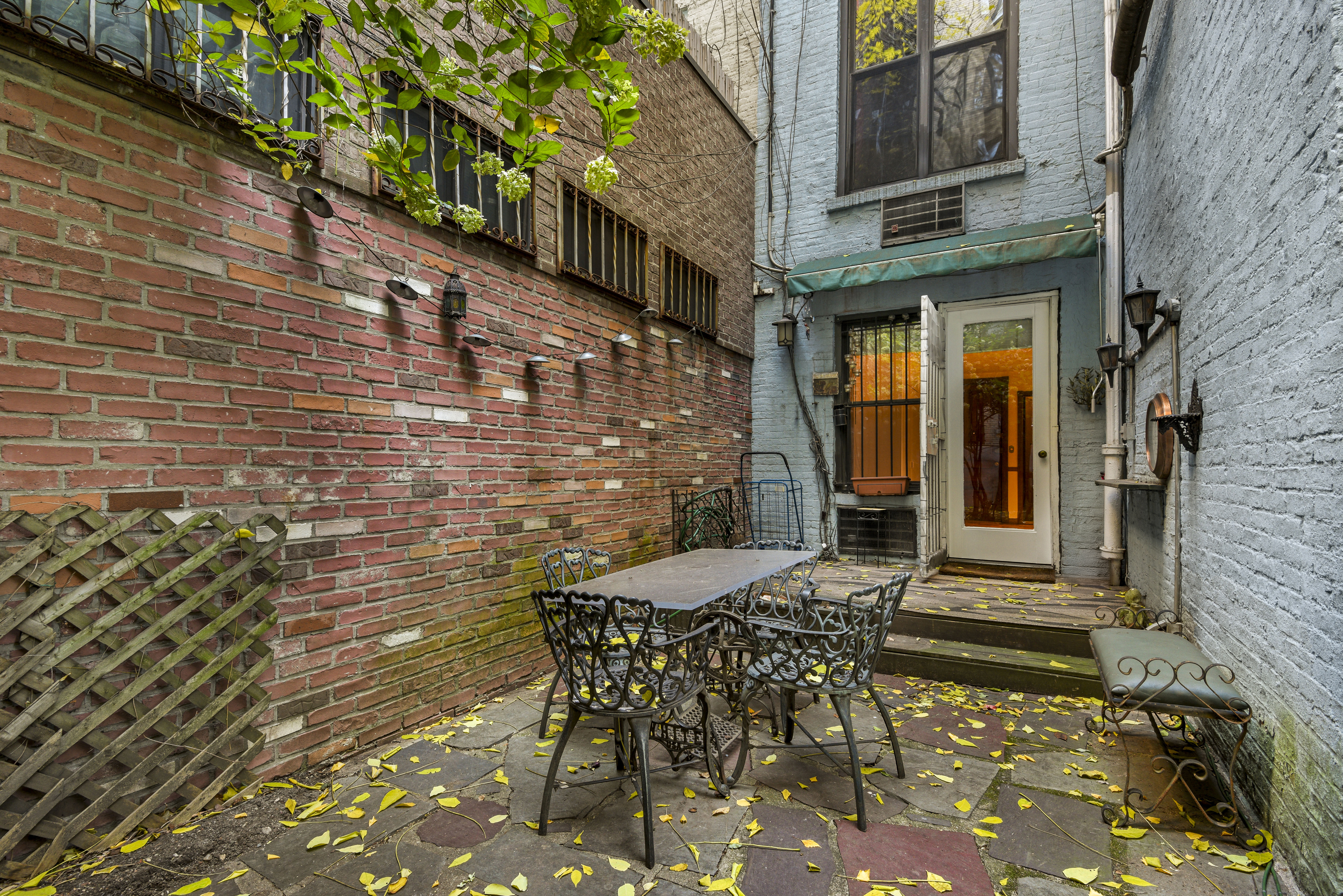 146 West 80th Street, Unit BR Manhattan, NY 10024 - Photo 13 of 16 a view of a brick house with table and chairs