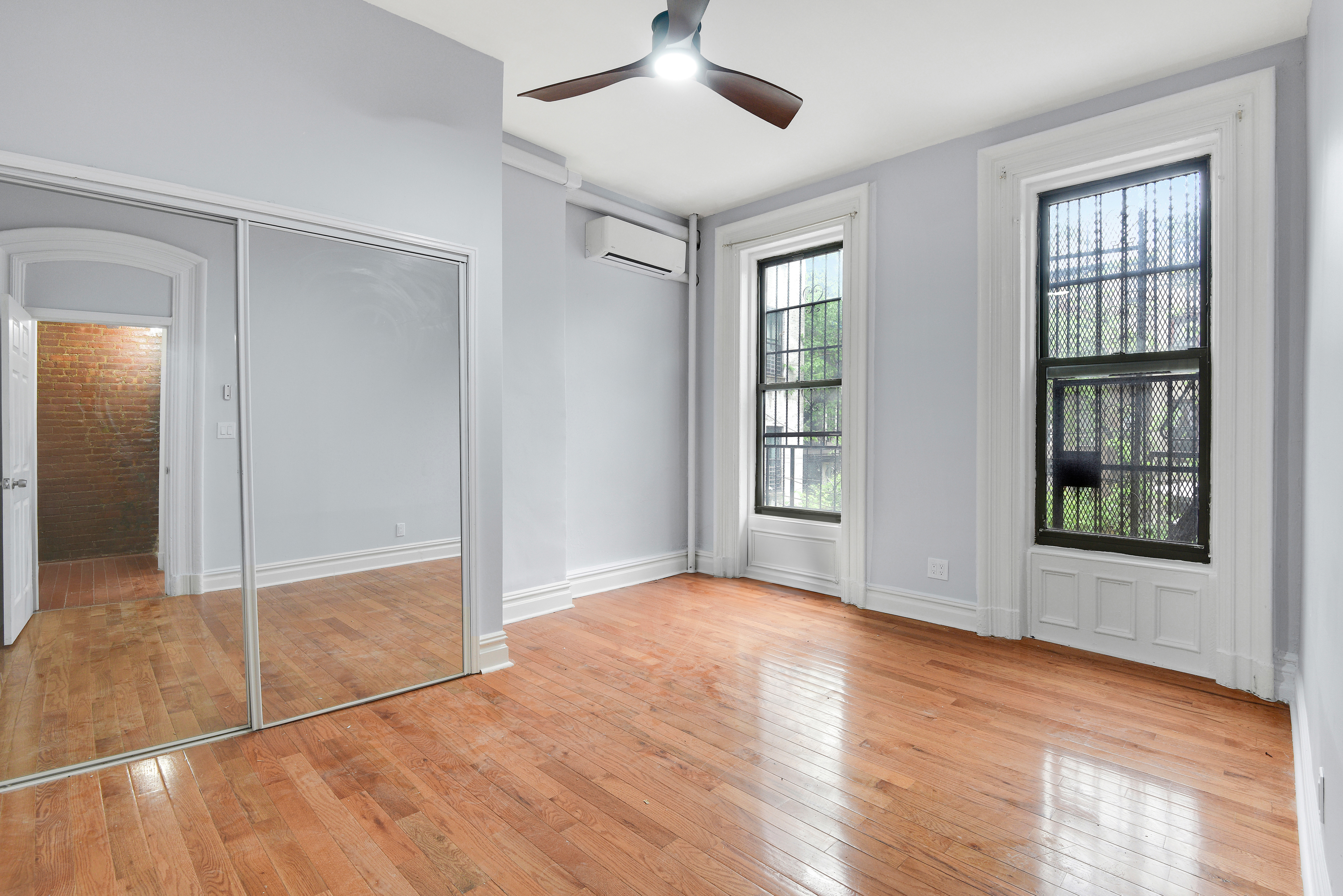 615 Willoughby Avenue, Unit 1 Brooklyn, NY 11206 - Photo 5 of 13 a view of an empty room with window and wooden floor