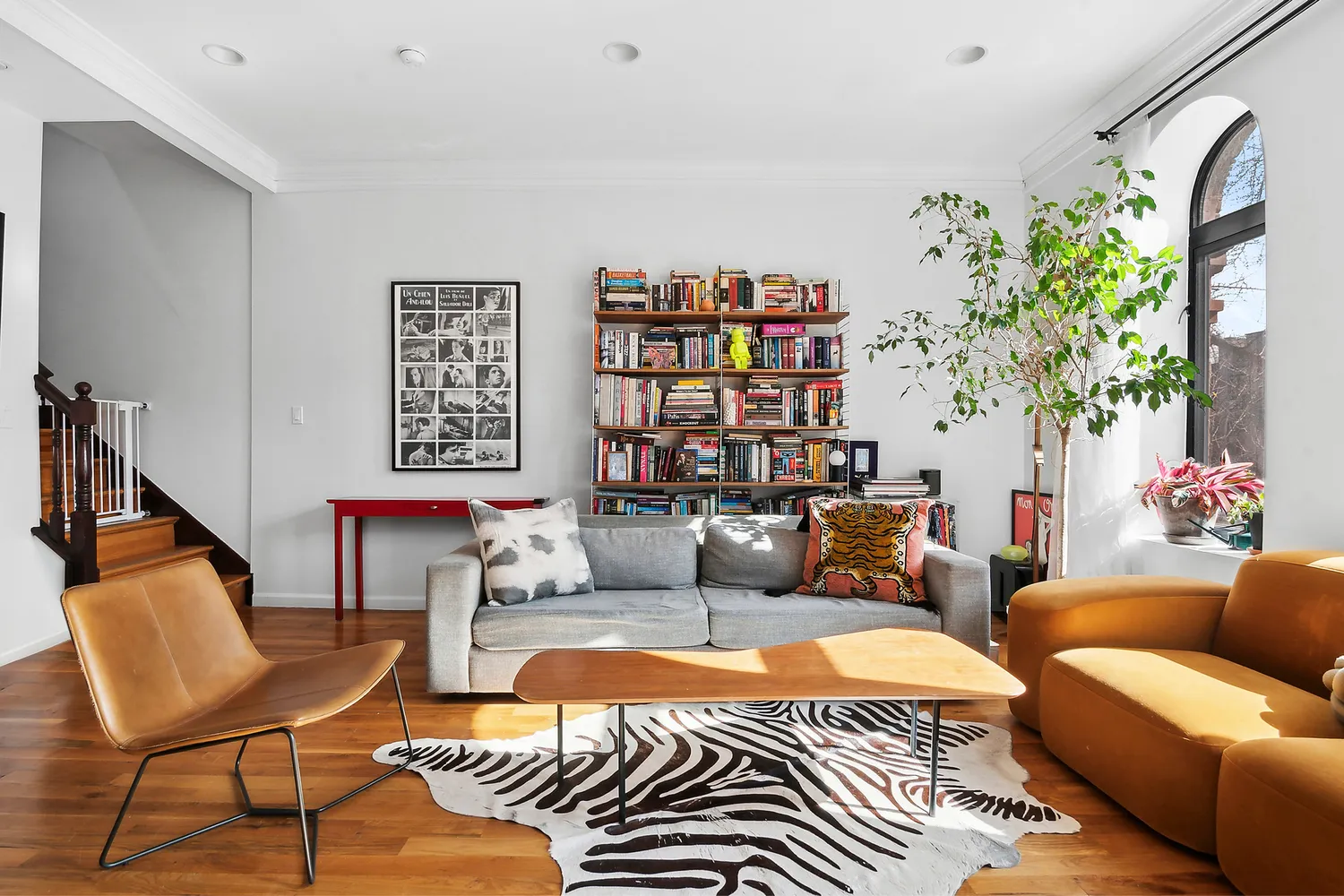 a living room with patio furniture and a potted plant