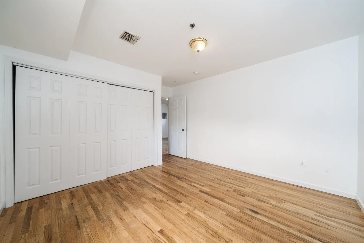 a view of a room with wooden floor