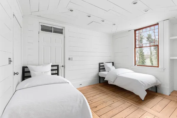 a bedroom with a bed and a window