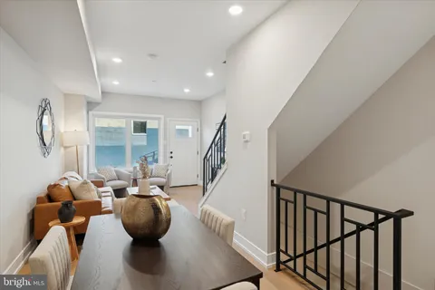 a living room with furniture wooden floor and a chandelier