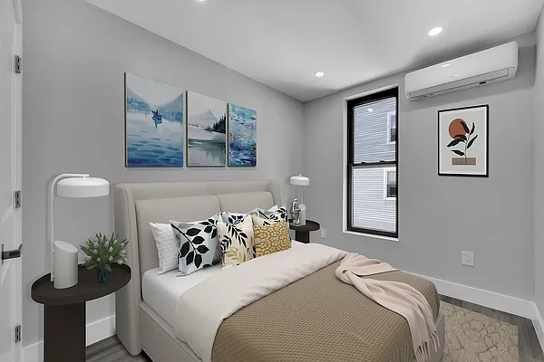 30 Marconi Place, Unit 2 Brooklyn, NY 11233 - Photo 9 of 11 a bedroom with a bed and a potted plant