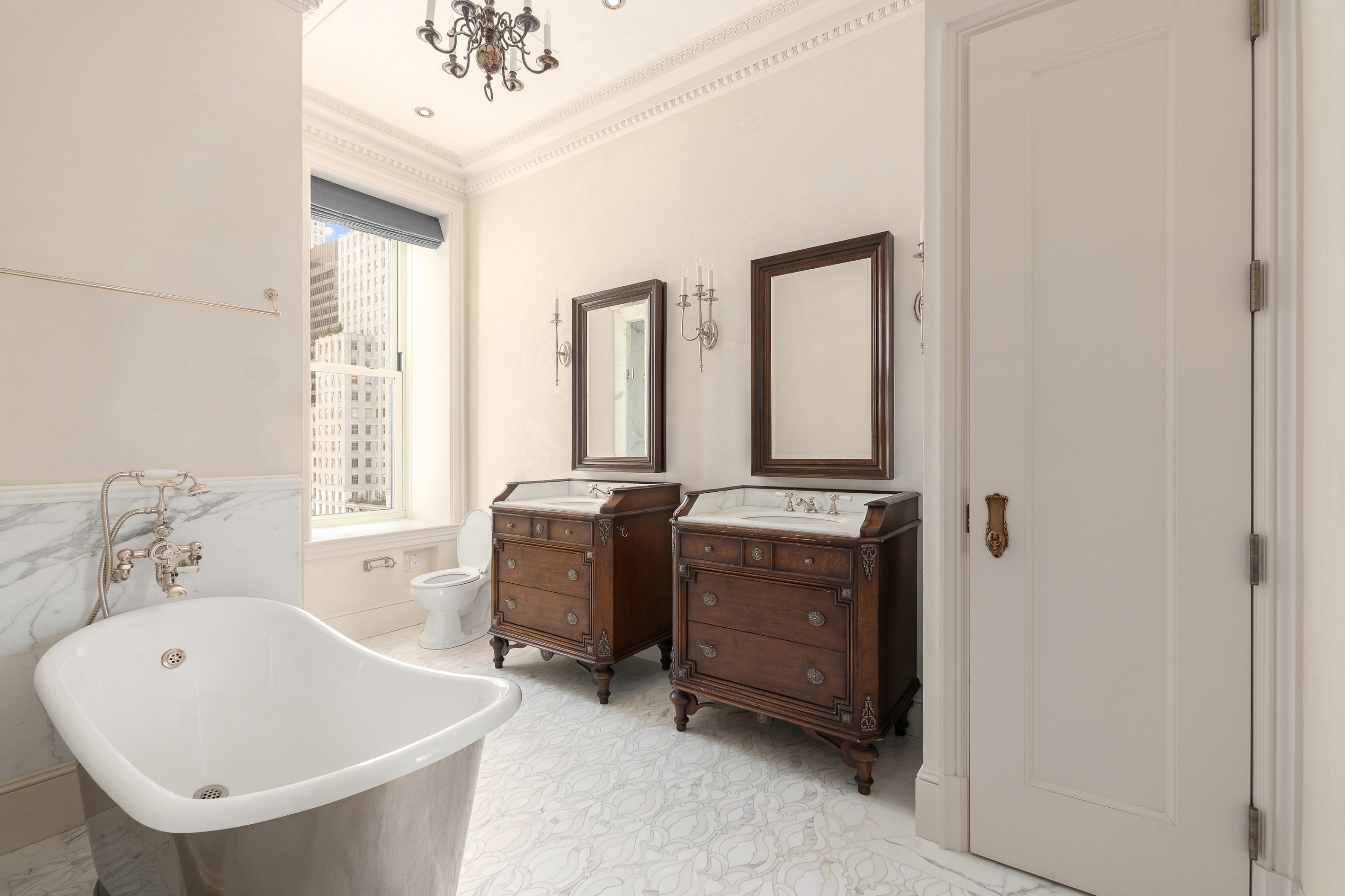 1 Central Park South, Unit 909915 Manhattan, NY 10019 - Photo 10 of 40 a bathroom with a sink a mirror and a bathtub