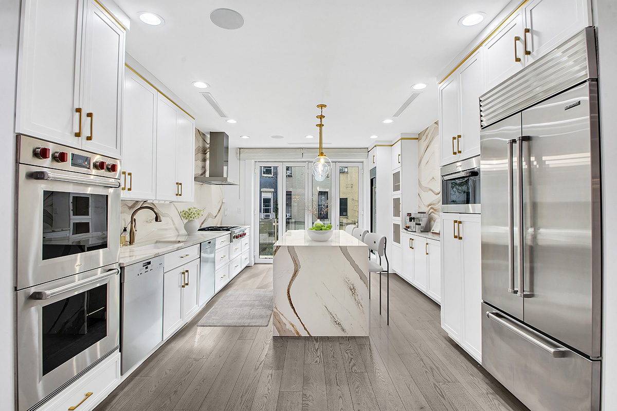 208 West 122nd Street Manhattan, NY 10027 - Photo 2 of 22 a large kitchen with stainless steel appliances a stove a sink and a refrigerator