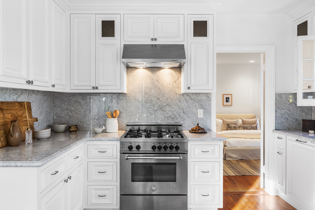 926 Burnside Avenue Los Angeles, CA 90036 - Photo 20 of 71 a kitchen with white cabinets and appliances