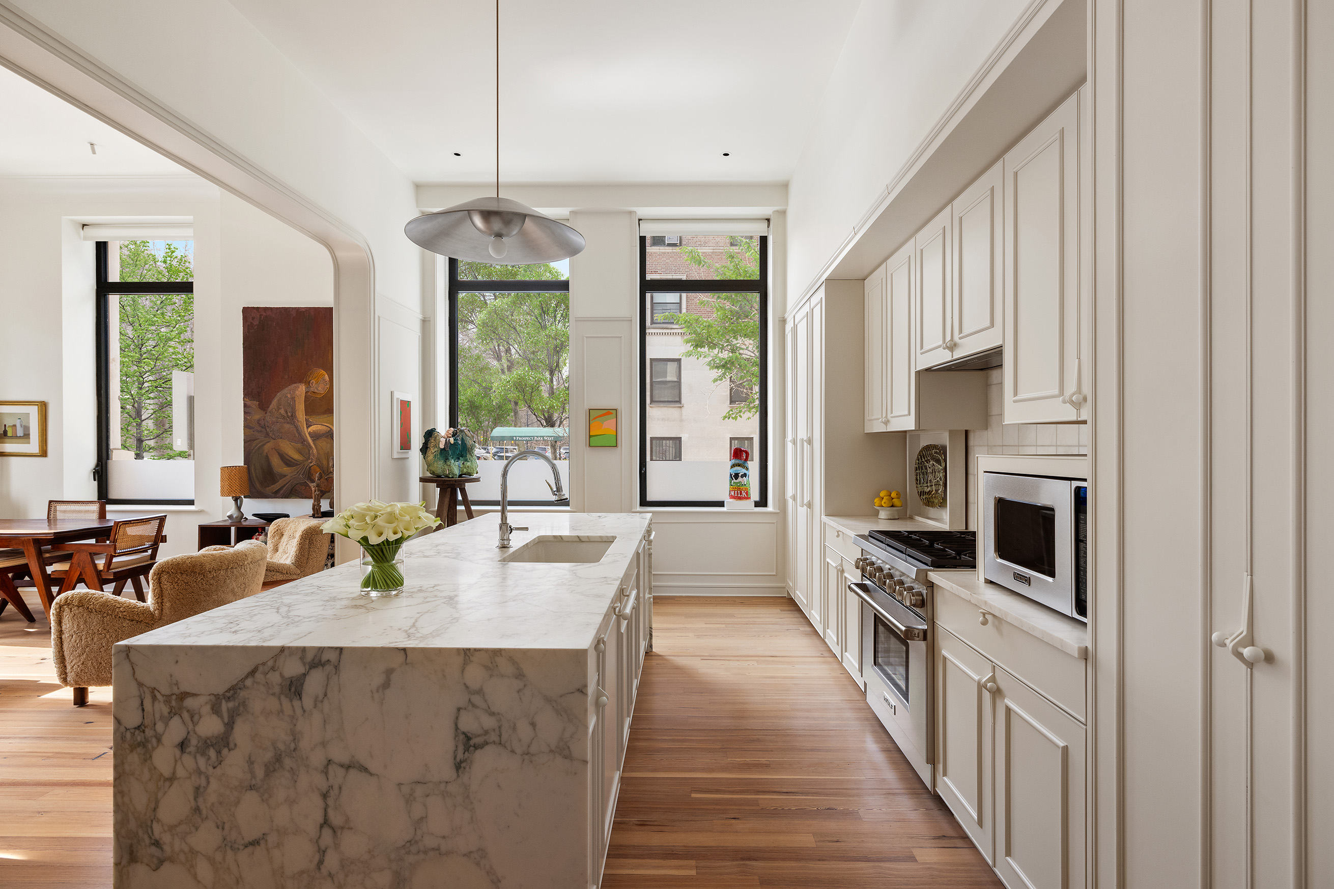 1 Prospect Park West, Unit 2B Brooklyn, NY 11215 - Photo 6 of 23 a large kitchen with kitchen island granite countertop a large counter top appliances a sink and living room view