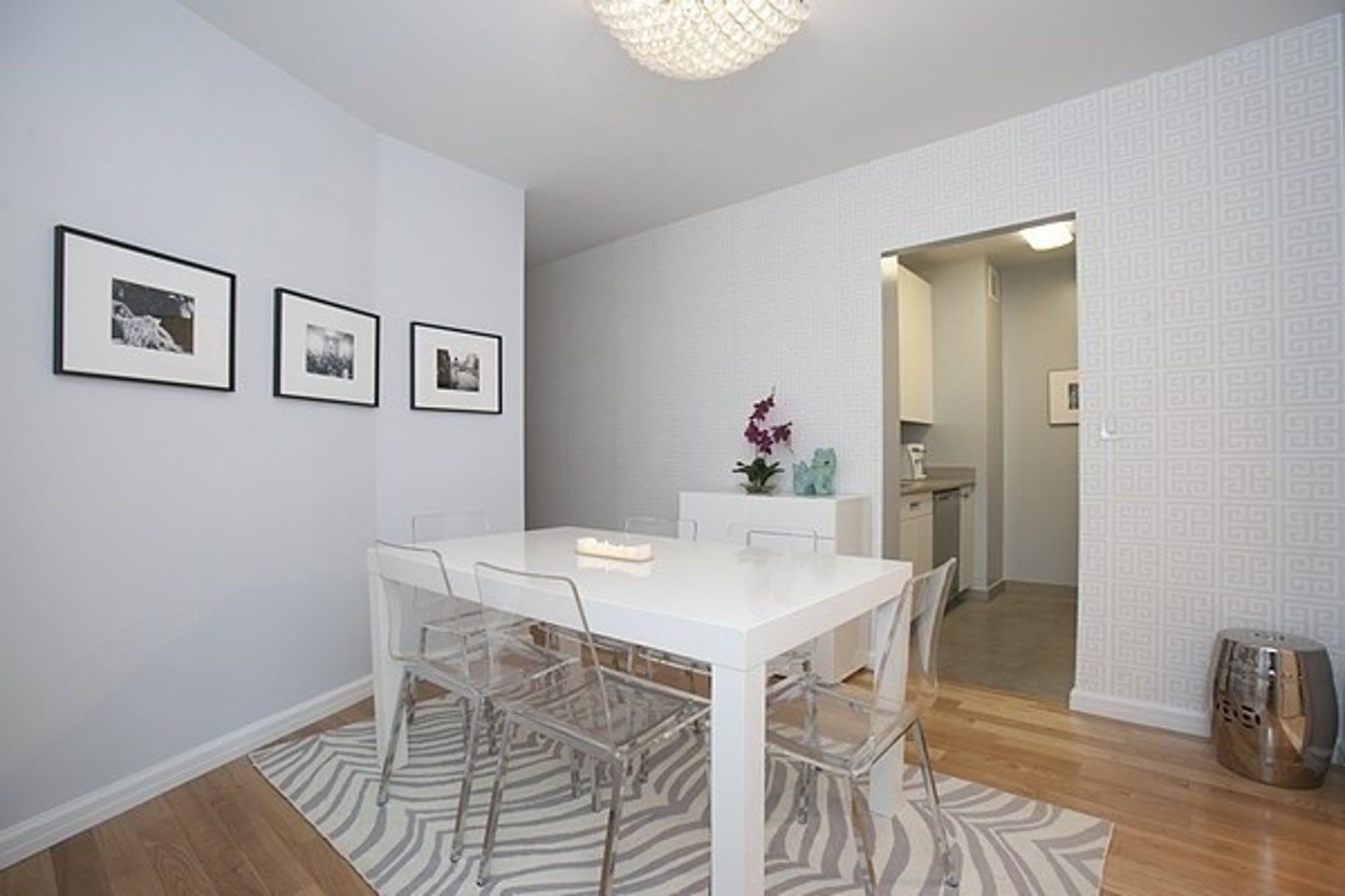 99 John Street, Unit 926 Manhattan, NY 10038 - Photo 2 of 12 a view of a dining room with furniture and wooden floor