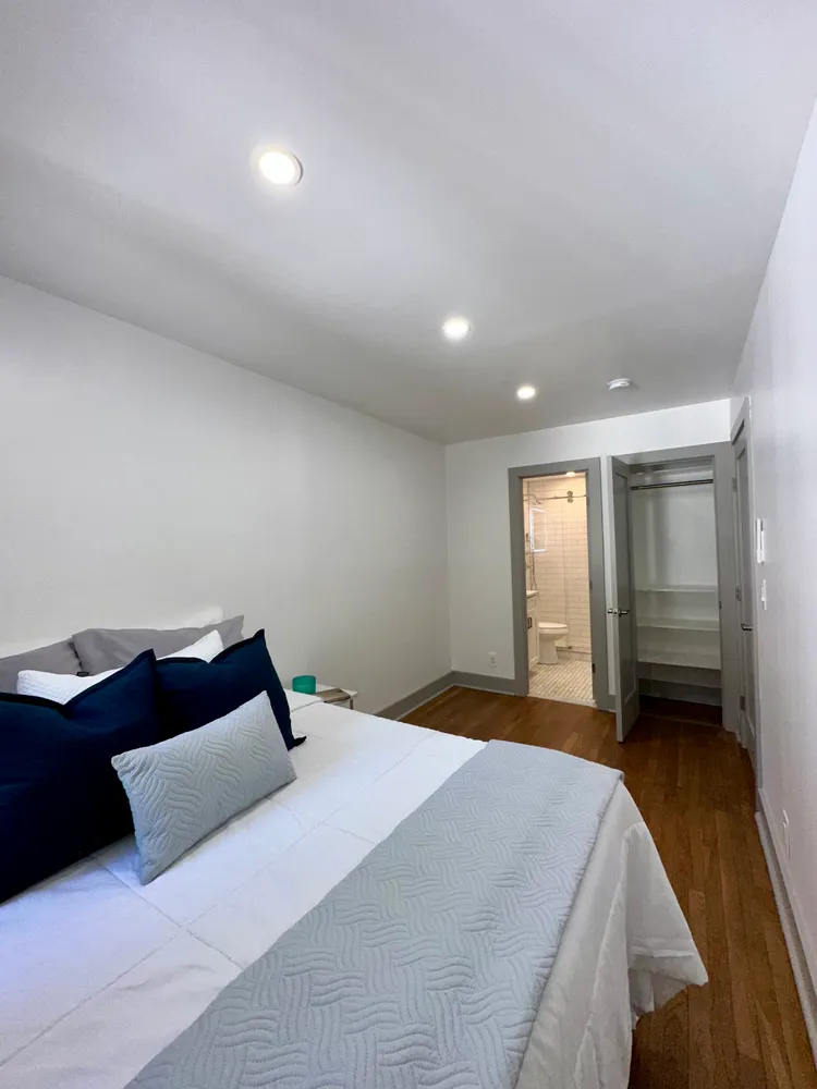 a bedroom with a large bed and a tv