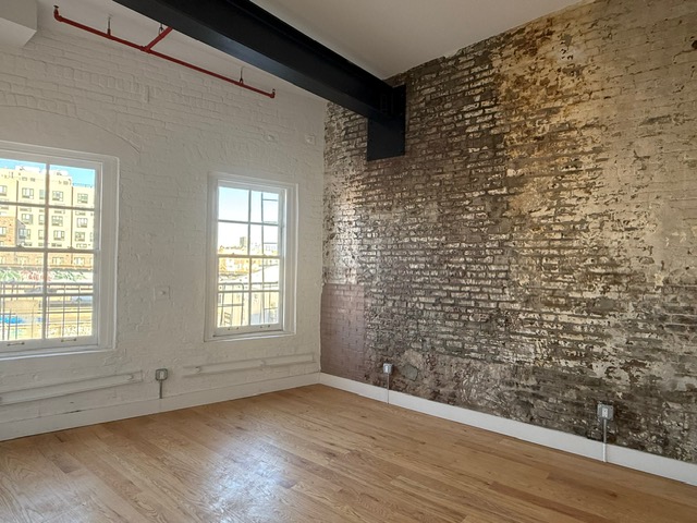 103 Broadway, Unit PH Brooklyn, NY 11249 - Photo 5 of 8 a view of an empty room and window