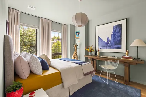 a bedroom with a bed and a chandelier