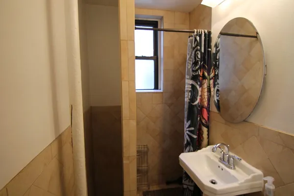 a bathroom with a sink toilet and mirror