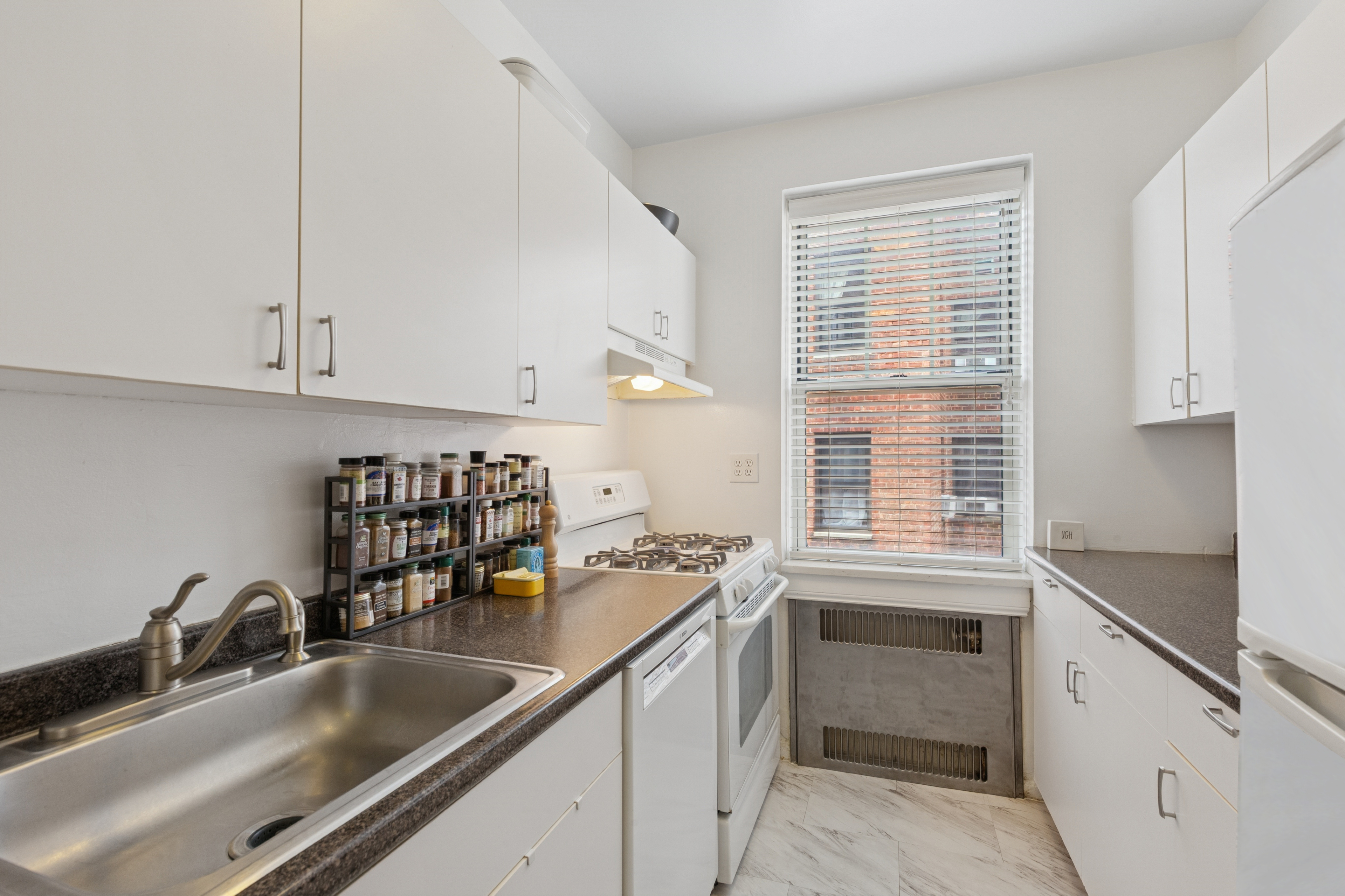 720 Fort Washington Avenue, Unit 5D Manhattan, NY 10040 - Photo 5 of 17 a kitchen with granite countertop a sink and a window