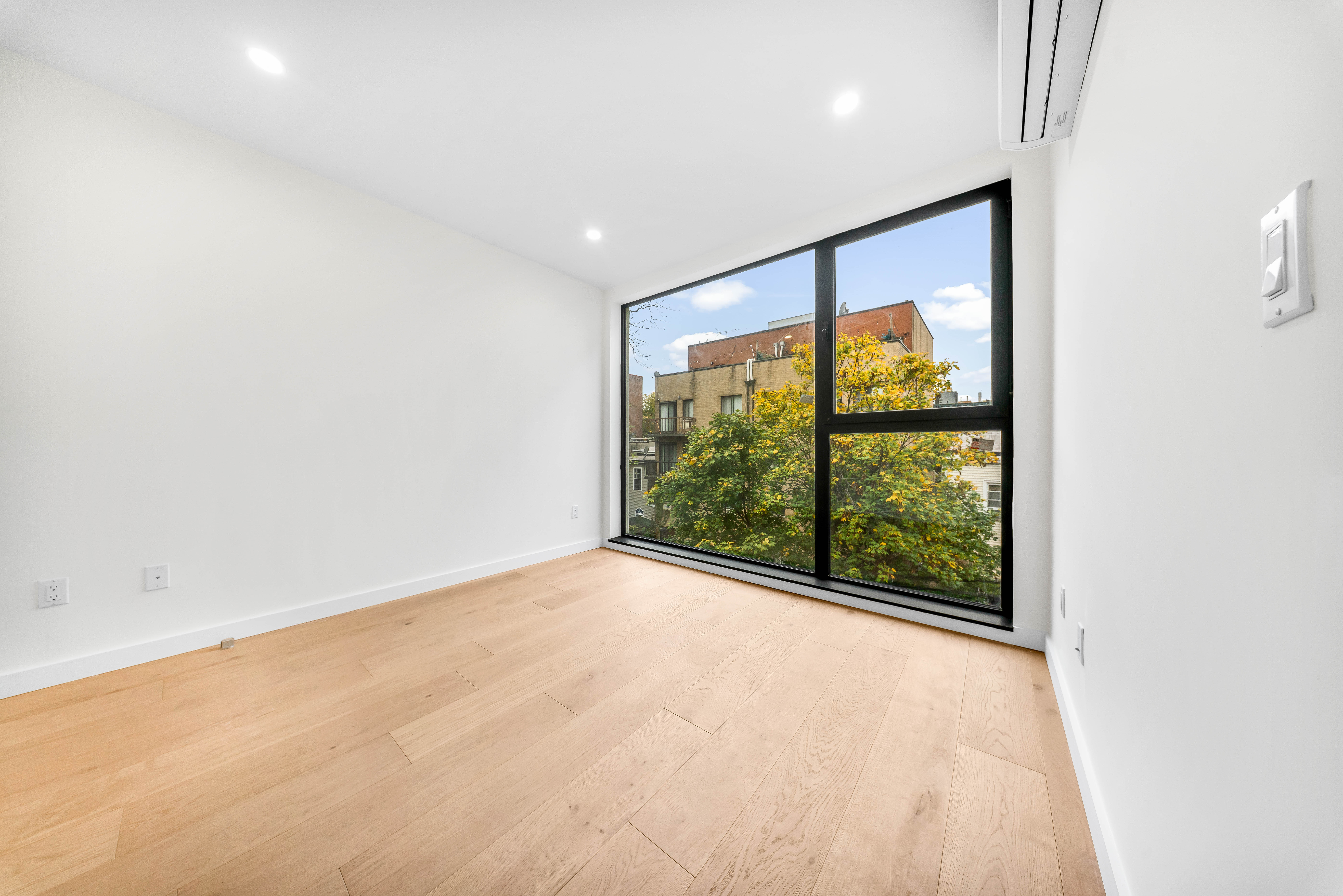30-24 32nd Street, Unit 3A Queens, NY 11102 - Photo 13 of 18 a view of an empty room with a window