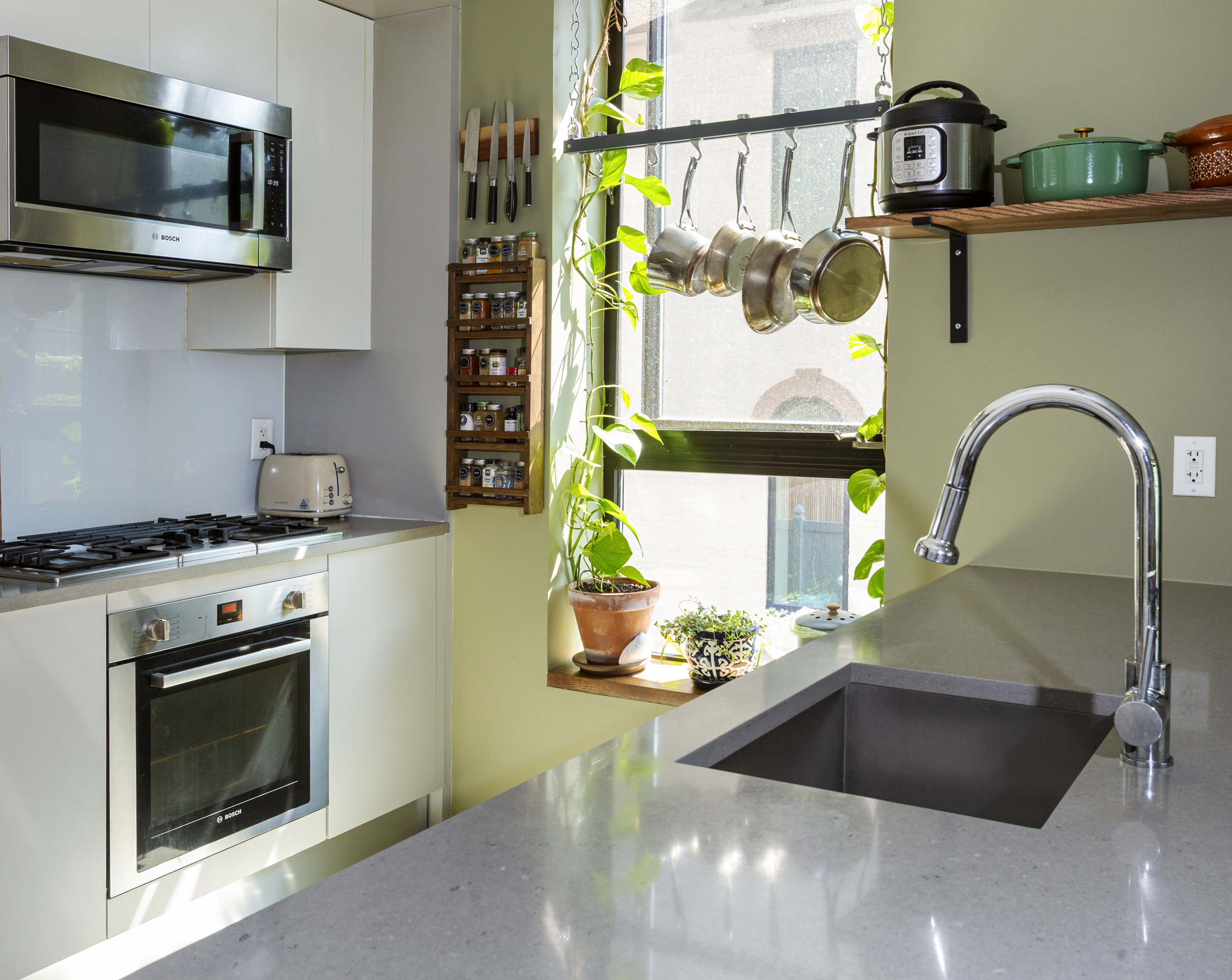 854 Putnam Avenue, Unit 2B Brooklyn, NY 11221 - Photo 5 of 12 a kitchen with a stove a microwave and cabinets