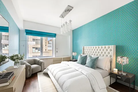 a bedroom with a bed couch and a window