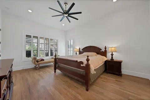 a bedroom with a bed and a large window