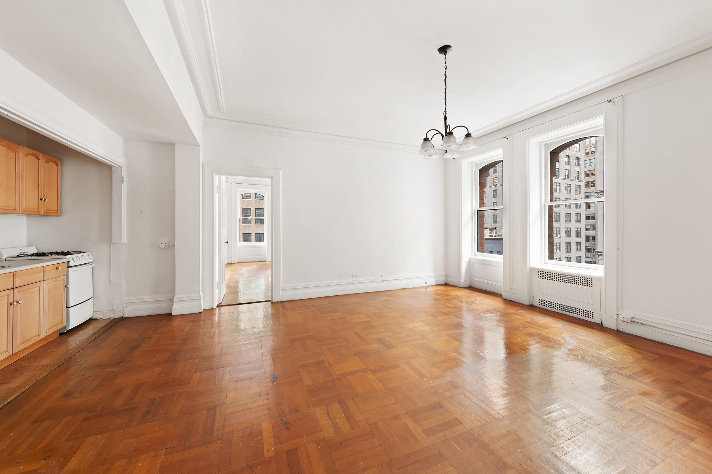 284 5th Avenue, Unit 6E Manhattan, NY 10001 - Photo 5 of 12 a view of an empty room with window and wooden floor