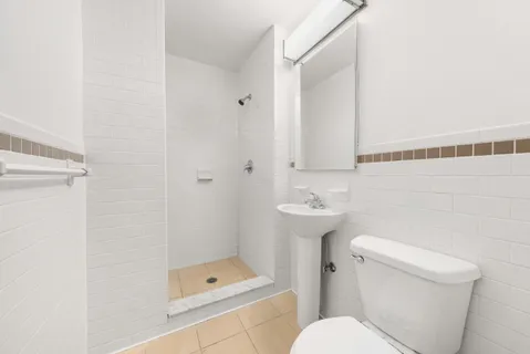 a bathroom with a toilet a sink and shower