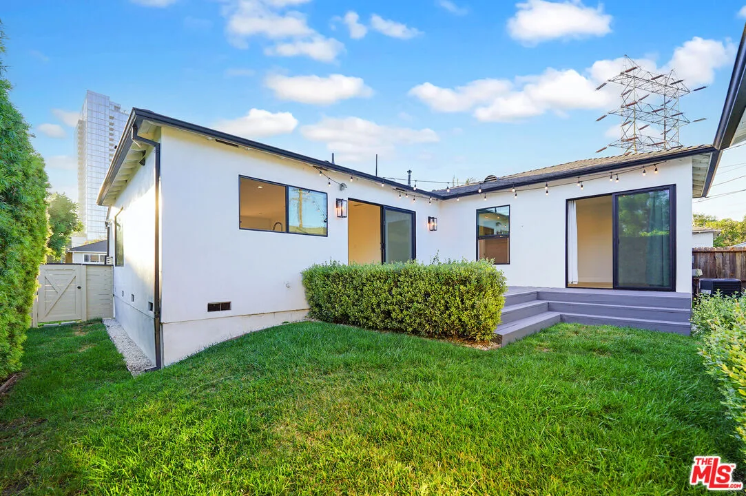 a dining room with furniture potted plants and wooden floor