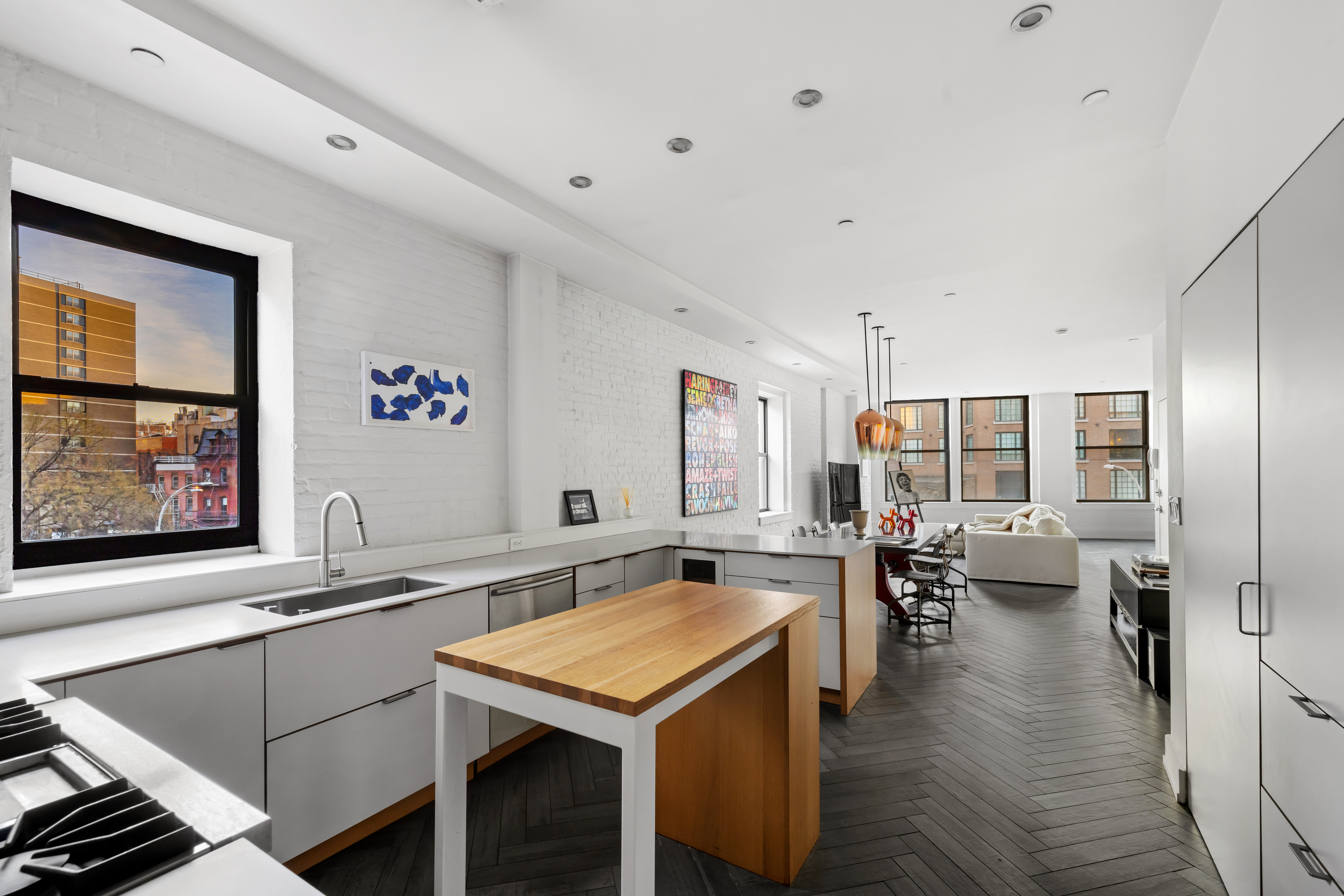 344 Bowery, Unit 3 Manhattan, NY 10012 - Photo 3 of 9 a kitchen with sink cabinets and living room
