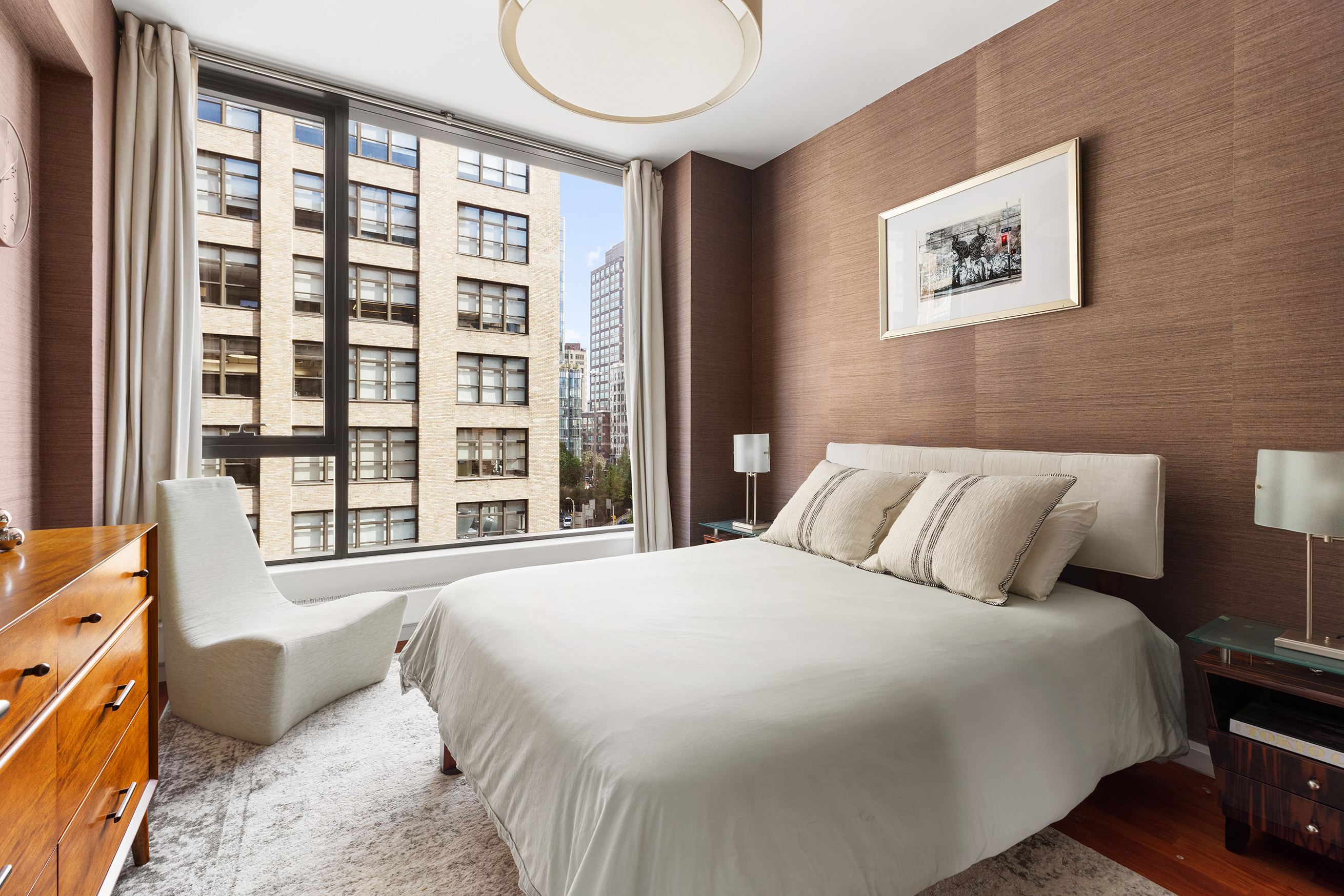 255 Hudson Street, Unit 6F Manhattan, NY 10013 - Photo 4 of 7 a bedroom with a large bed and a large window