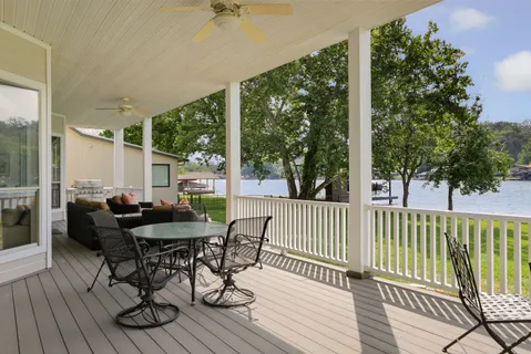 a view of a porch with furniture and wooden floor