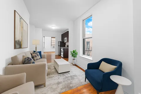 a living room with furniture and a large mirror