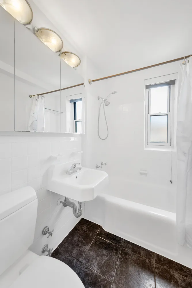 a bathroom with a sink toilet a mirror and shower